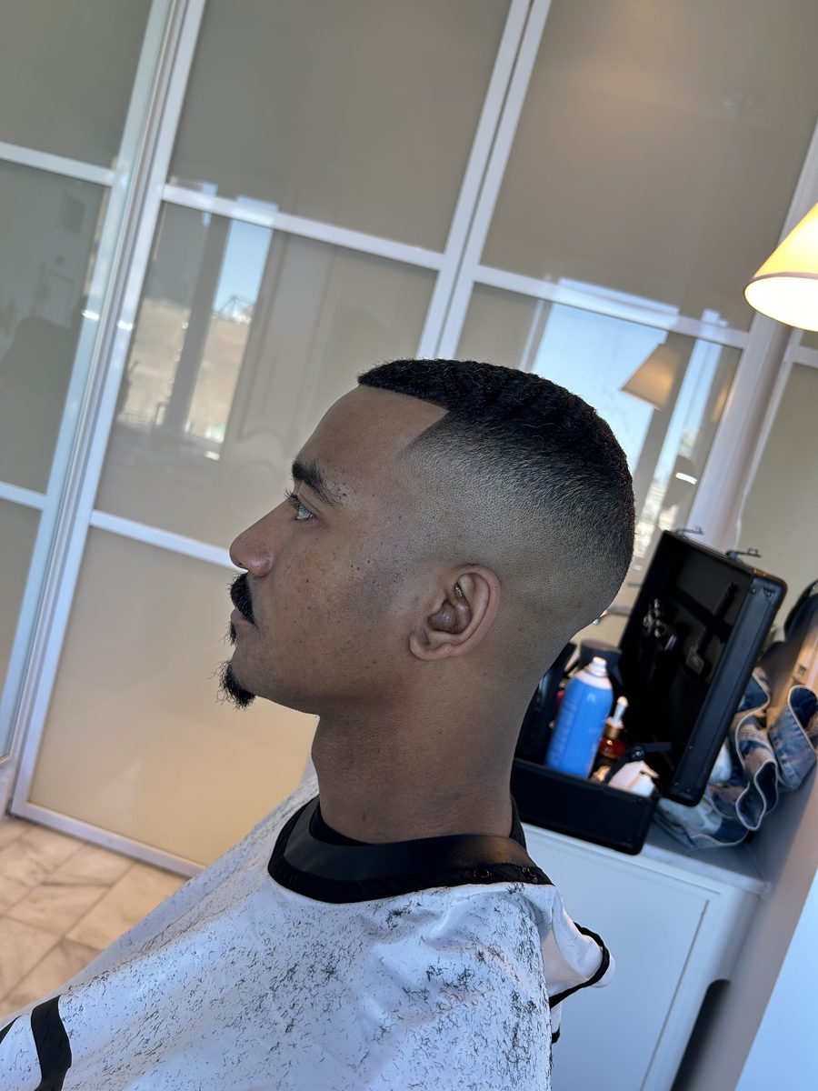 A finished cut by Barte: a clean high skin fade with a crisp lineup